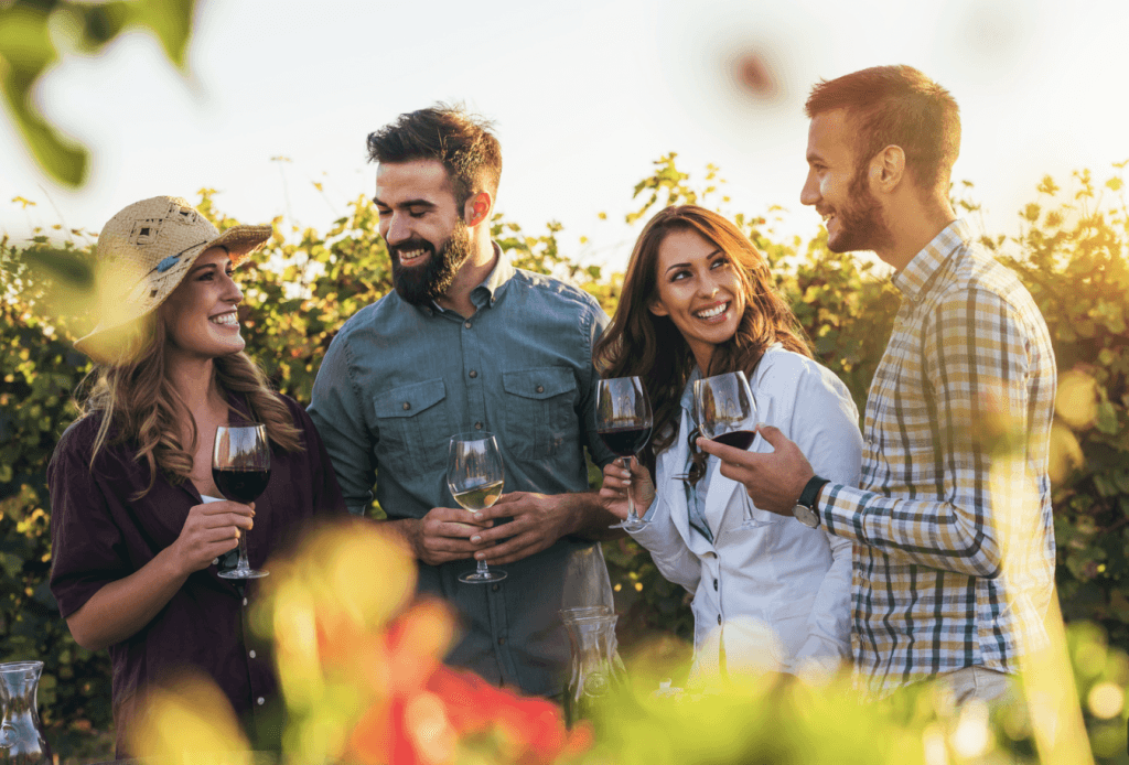 four people with wine glass in hand