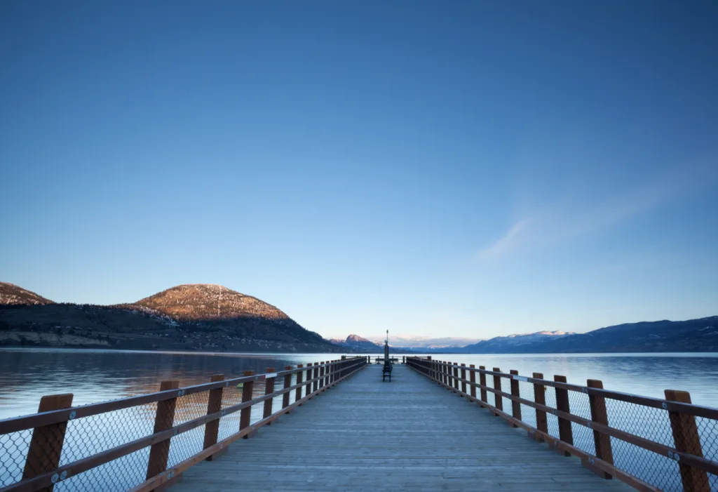 A picturesque pier set against a stunning mountain backdrop, showcasing the beauty of nature and outdoor adventures.