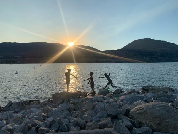 kids playing at sunset on Okanagan lake panorama